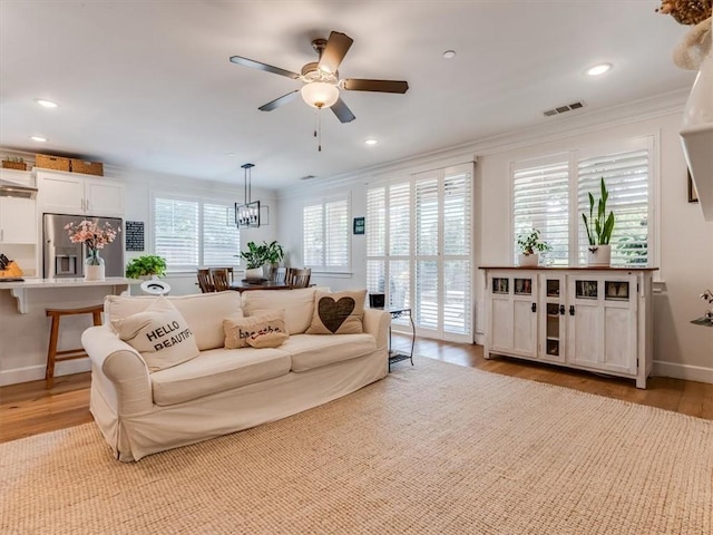 8670 Erika Ct, Atascadero, CA 93422 - living room with crown molding, light wood finished floors, a ceiling fan, baseboards, and recessed lighting