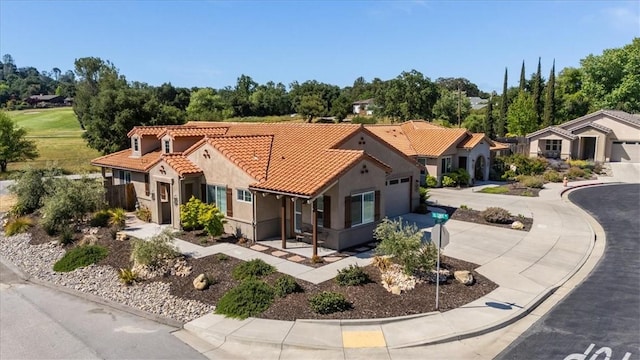 8670 Erika Ct, Atascadero, CA 93422 - mediterranean / spanish home with concrete driveway, stucco siding, a tiled roof, and an attached garage