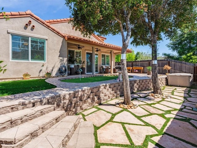 8670 Erika Ct, Atascadero, CA 93422 - back of property featuring a ceiling fan, a patio, a hot tub, stucco siding, and a fenced backyard