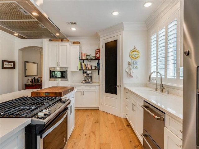 8670 Erika Ct, Atascadero, CA 93422 - kitchen with appliances with stainless steel finishes, ventilation hood, a sink, wooden counters, and light wood-style floors