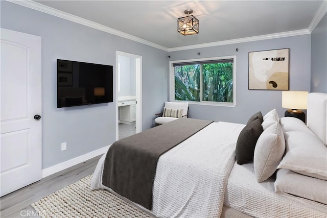 bedroom featuring wood finished floors, ornamental molding, baseboards, and ensuite bathroom