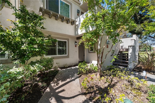 entrance to property featuring stucco siding