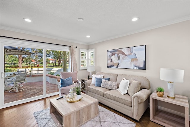 living room with ornamental molding, recessed lighting, wood finished floors, baseboards, and a textured ceiling
