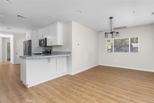 9019 San Gabriel Rd, Atascadero, CA 93422 - kitchen featuring appliances with stainless steel finishes, white cabinets, light wood finished floors, baseboards, and recessed lighting