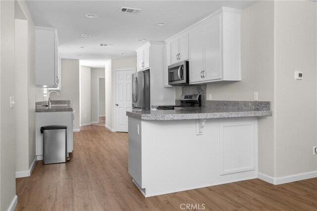 9019 San Gabriel Rd, Atascadero, CA 93422 - kitchen with appliances with stainless steel finishes, baseboards, white cabinetry, and recessed lighting