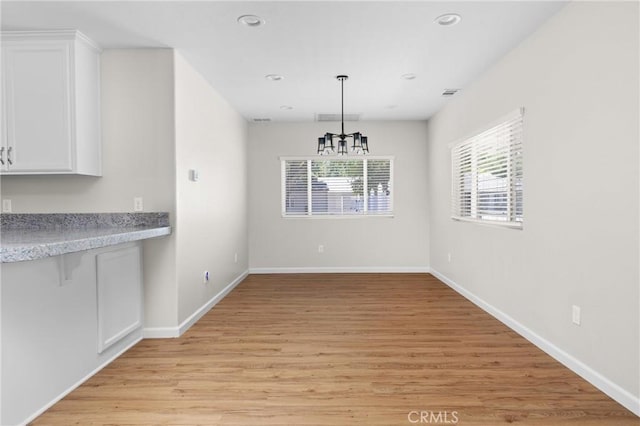 9019 San Gabriel Rd, Atascadero, CA 93422 - unfurnished dining area featuring light wood-style floors, a chandelier, baseboards, and recessed lighting