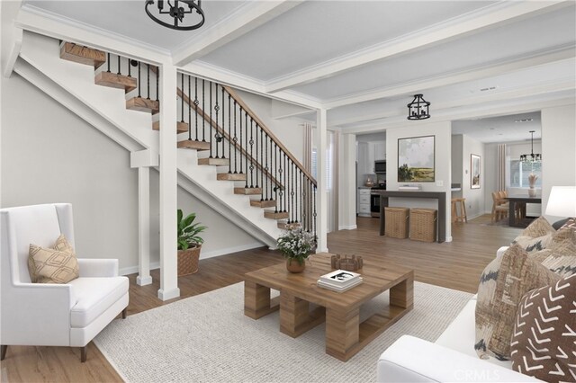 9019 San Gabriel Rd, Atascadero, CA 93422 - living room featuring a chandelier, stairway, wood finished floors, and beam ceiling