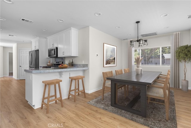 9019 San Gabriel Rd, Atascadero, CA 93422 - dining room with light wood-type flooring, baseboards, a chandelier, and recessed lighting