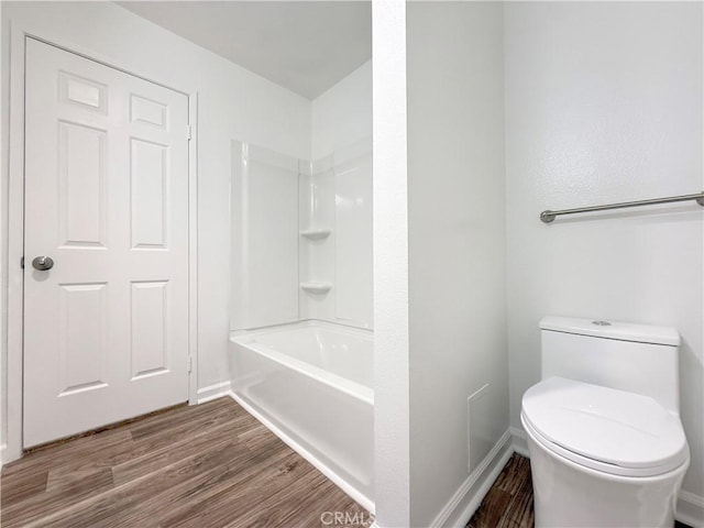 full bathroom featuring wood finished floors, toilet, and baseboards