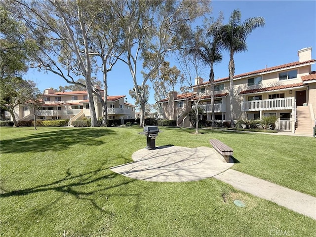 view of home's community featuring a yard and a residential view