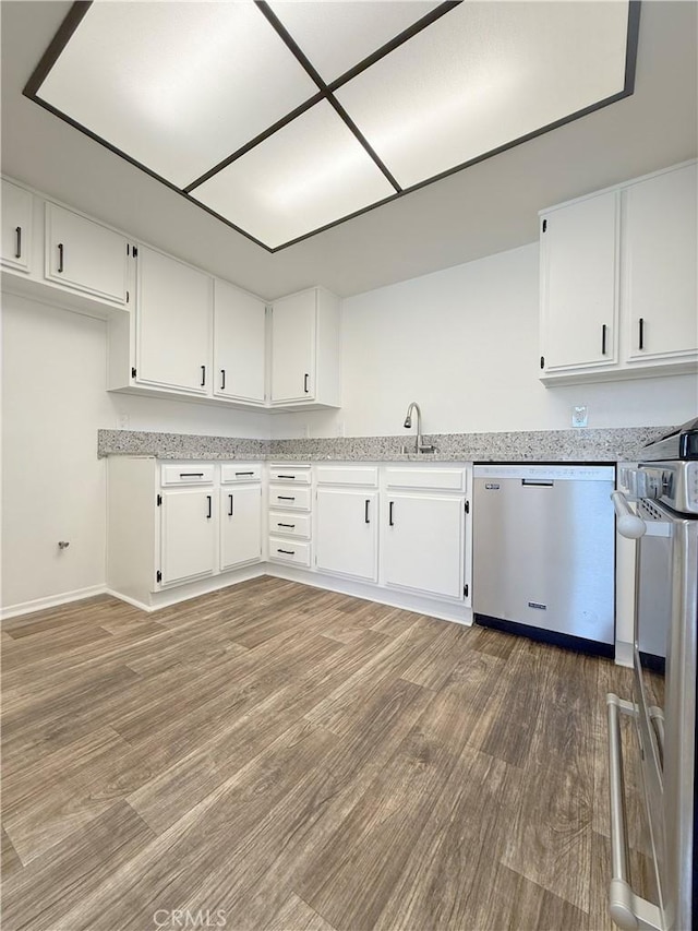 kitchen featuring stainless steel dishwasher, stove, white cabinetry, and light wood-style floors