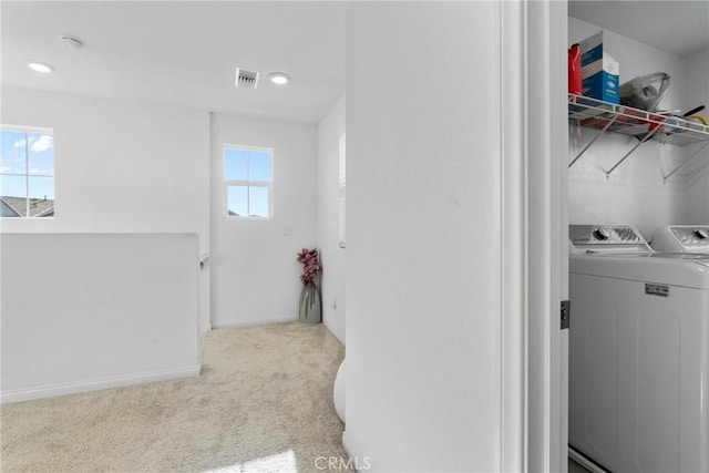 laundry area with separate washer and dryer, carpet floors, baseboards, and recessed lighting