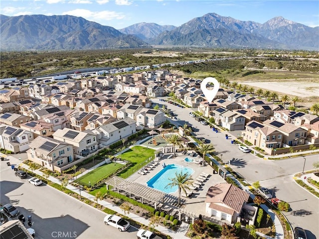 drone / aerial view of mountains and a pool