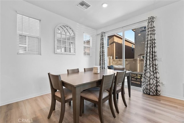 dining room with light wood-style floors and baseboards