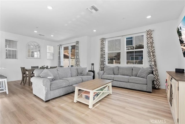 living room with light wood-style floors and recessed lighting