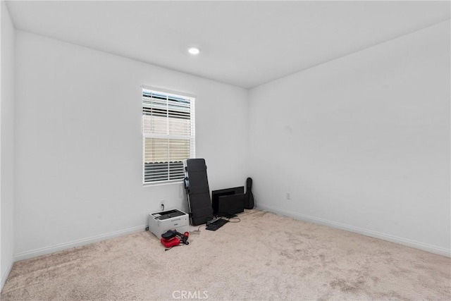 carpeted empty room with baseboards and recessed lighting