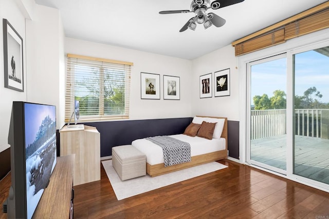 bedroom featuring multiple windows, access to outside, baseboards, and hardwood / wood-style flooring