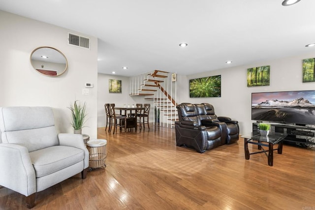 living room featuring stairway, recessed lighting, and wood finished floors