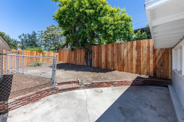 fenced backyard with a patio area