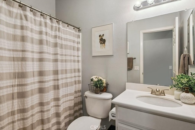 full bath with vanity, toilet, and a shower with curtain