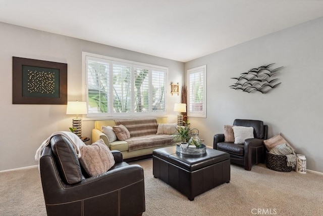living room featuring light carpet and baseboards