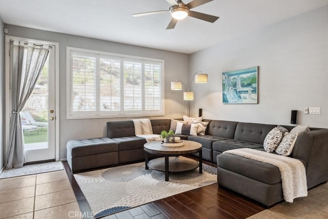 living area with a ceiling fan and wood finished floors
