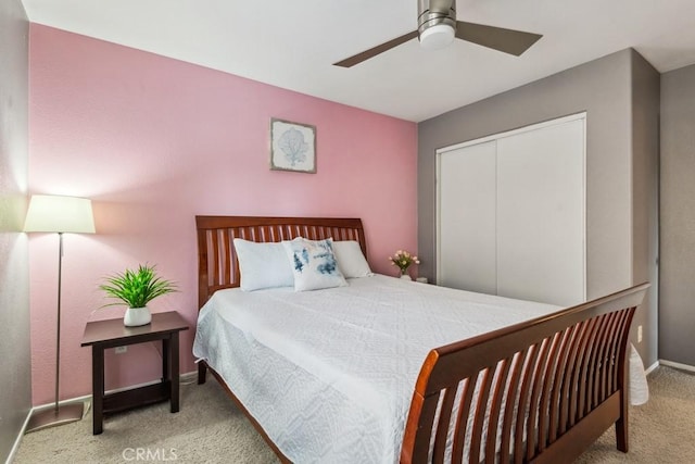 bedroom with carpet flooring, baseboards, a closet, and ceiling fan