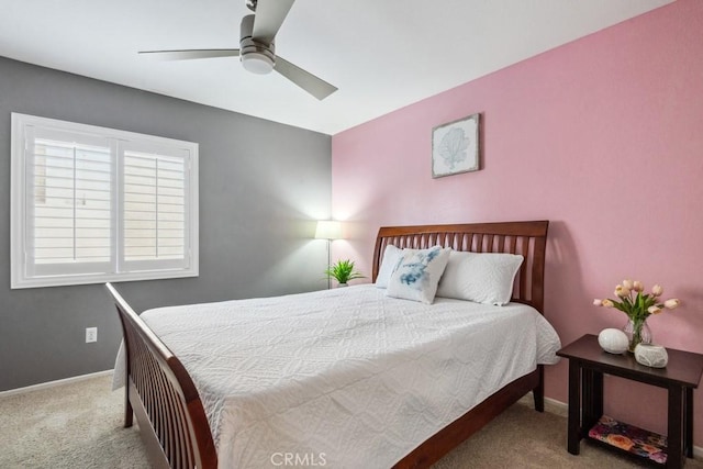 carpeted bedroom featuring baseboards and ceiling fan