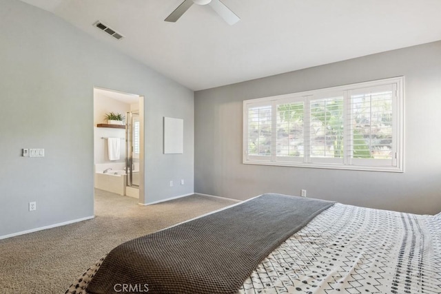 carpeted bedroom with vaulted ceiling, baseboards, connected bathroom, and a ceiling fan