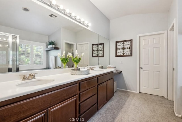 full bath with lofted ceiling, a shower with door, double vanity, and baseboards