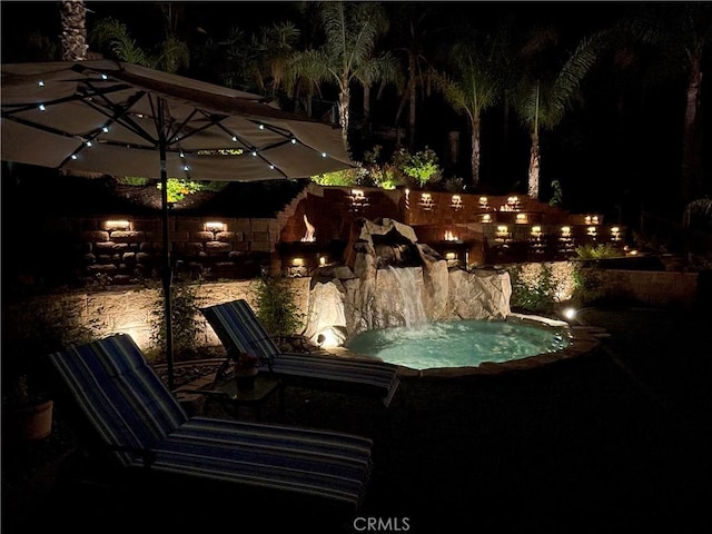 patio at twilight with a hot tub