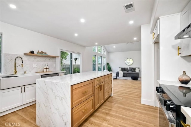 5166 Via Portola, Oceanside, CA 92057 - kitchen with a sink, vaulted ceiling, tasteful backsplash, stove, and open shelves