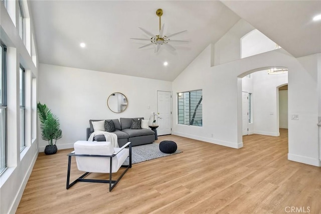5166 Via Portola, Oceanside, CA 92057 - living room featuring high vaulted ceiling, a ceiling fan, healthy amount of natural light, arched walkways, and baseboards