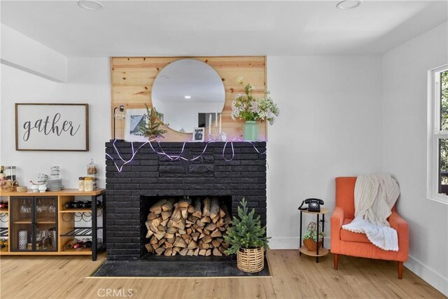22384 Crest Forest Dr, Cedarpines Park, CA 92322 - sitting room featuring a fireplace, baseboards, and wood finished floors