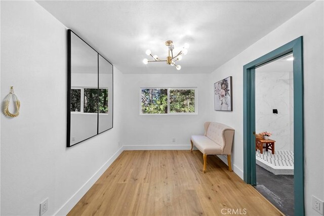 22384 Crest Forest Dr, Cedarpines Park, CA 92322 - sitting room featuring baseboards, light wood-type flooring, and a chandelier