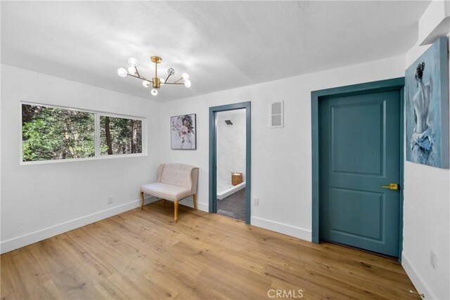 22384 Crest Forest Dr, Cedarpines Park, CA 92322 - living area with a chandelier, baseboards, and wood finished floors