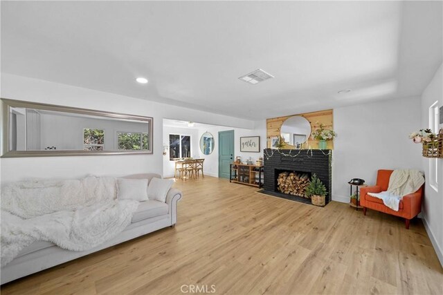 22384 Crest Forest Dr, Cedarpines Park, CA 92322 - living area with wood finished floors, a brick fireplace, recessed lighting, and baseboards