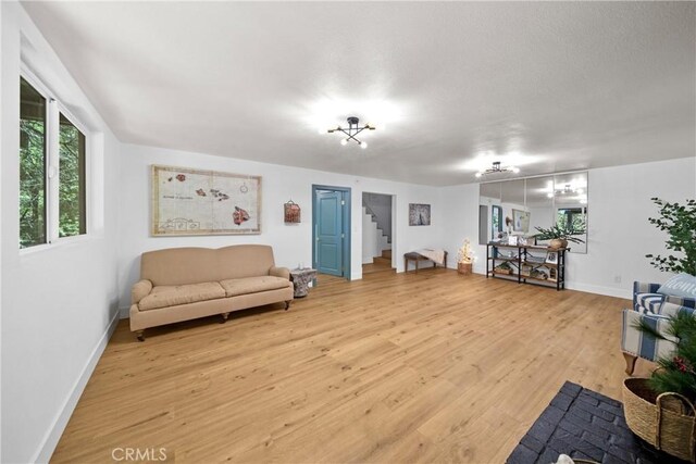 22384 Crest Forest Dr, Cedarpines Park, CA 92322 - living room featuring light wood finished floors, stairway, and baseboards