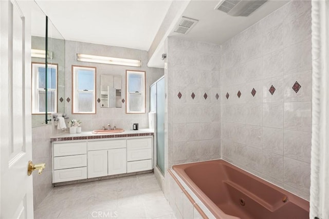 335 Montechico Dr, Monterey Park, CA 91754 - full bathroom featuring tile walls, a tile shower, a jetted tub, vanity, and tile patterned floors