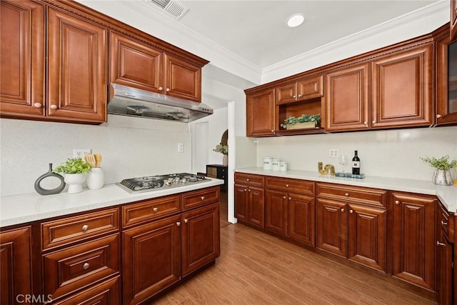 335 Montechico Dr, Monterey Park, CA 91754 - kitchen featuring under cabinet range hood, stainless steel gas stovetop, light countertops, light wood-type flooring, and ornamental molding