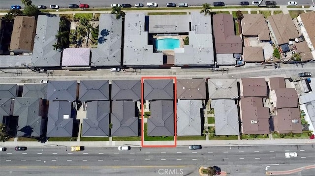 aerial view of residential area with property parcel outlined and a pool area