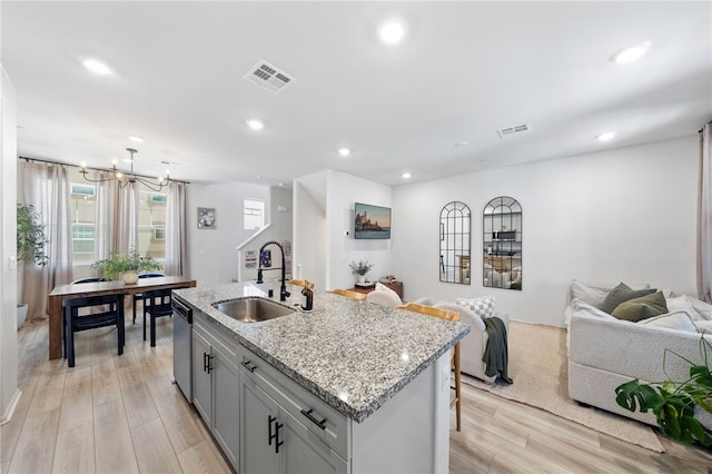 40545 Melrose Dr, Temecula, CA 92591 - kitchen featuring a sink, open floor plan, a chandelier, light wood finished floors, and a kitchen island with sink