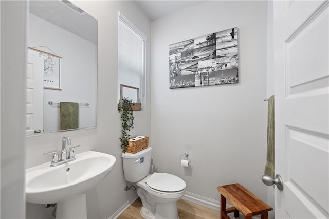 40545 Melrose Dr, Temecula, CA 92591 - half bath featuring toilet, wood finished floors, baseboards, and a sink