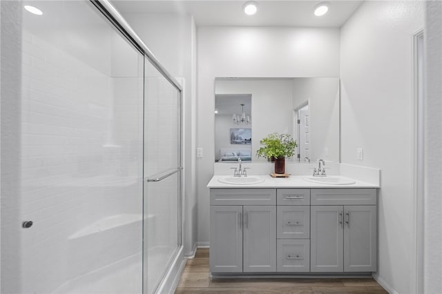 40545 Melrose Dr, Temecula, CA 92591 - full bathroom featuring double vanity, a stall shower, and wood finished floors
