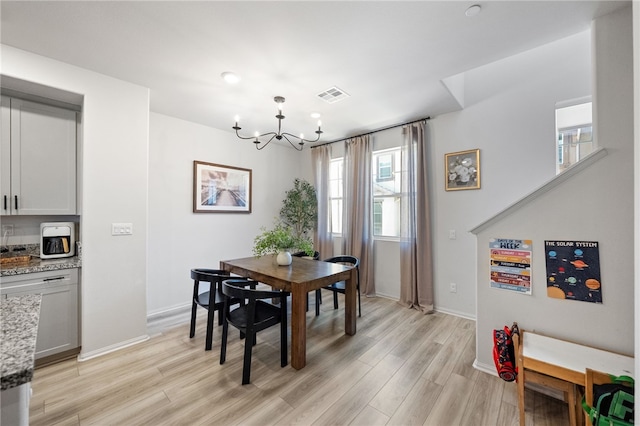 40545 Melrose Dr, Temecula, CA 92591 - dining room featuring a chandelier, healthy amount of natural light, light wood-type flooring, and baseboards