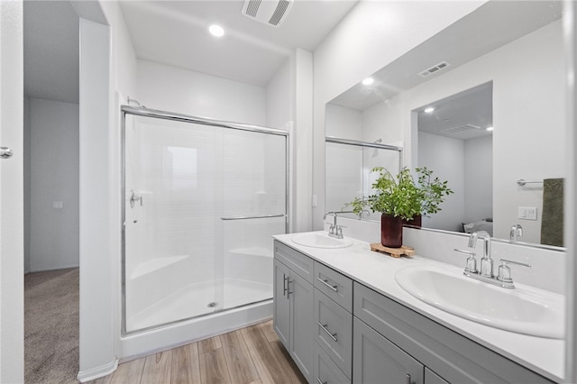 40545 Melrose Dr, Temecula, CA 92591 - full bath with double vanity, a stall shower, wood finished floors, and recessed lighting