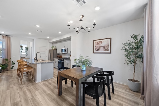 40545 Melrose Dr, Temecula, CA 92591 - dining area featuring light wood-type flooring, a chandelier, recessed lighting, and baseboards