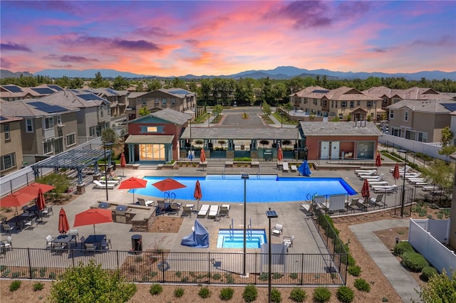 40545 Melrose Dr, Temecula, CA 92591 - pool at dusk with a residential view, a community pool, a mountain view, and a patio area