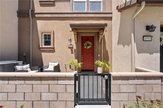40545 Melrose Dr, Temecula, CA 92591 - doorway to property featuring stucco siding, central air condition unit, and a gate