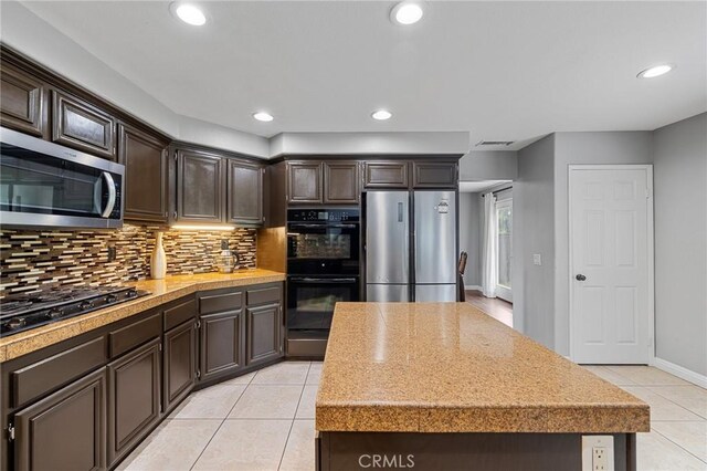 26426 Cardinal Dr, Canyon Country, CA 91387 - kitchen featuring black appliances, light tile patterned floors, decorative backsplash, light countertops, and recessed lighting